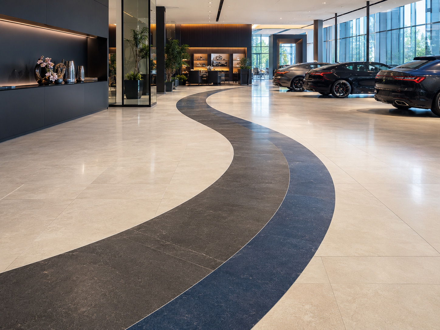 Hall de concession avec carrelage à motif courbe bicolore découpé au jet d’eau